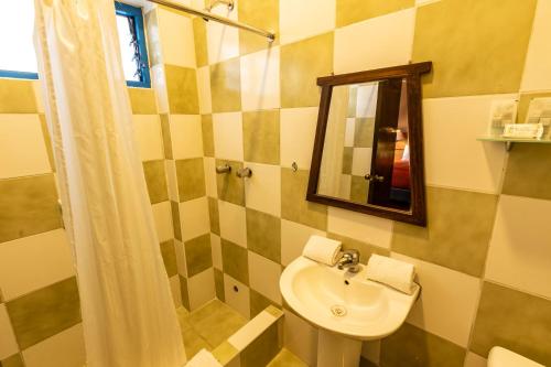 a bathroom with a sink and a mirror at La Casona de Rimacpampa in Cusco