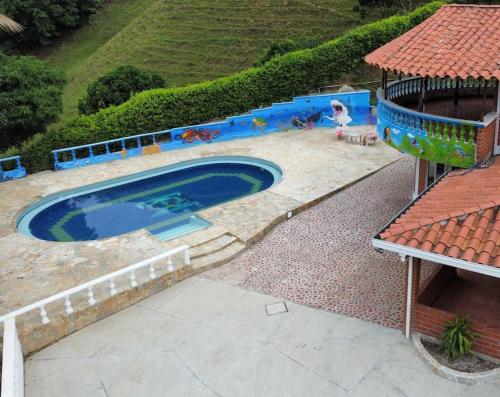 ein Schwimmbad in der Mitte eines Gartens in der Unterkunft Casa de campo cerca a Medellín in Titiribí