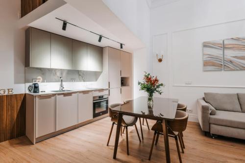 a kitchen and living room with a table and a couch at Stunning Apartment near Gran Via Metro in Madrid
