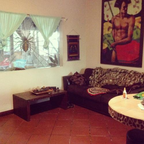 a living room with a couch and a table at Chosa Manglar Suites & Cabins in Puerto Jiménez
