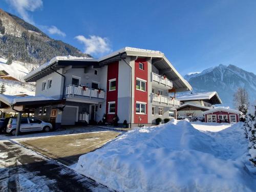 a pile of snow in front of a building at Appartement Gimpl in Fusch an der Glocknerstraße