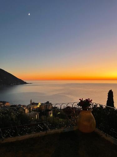 a view of the ocean at sunset from a balcony at Villa Mortola in Camogli