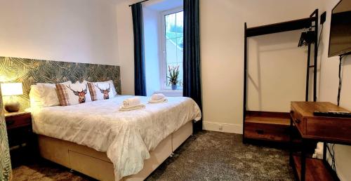 a bedroom with a bed with a mirror and a dresser at CHARMING VICTORIAN APARTMENT, central location in Inverness
