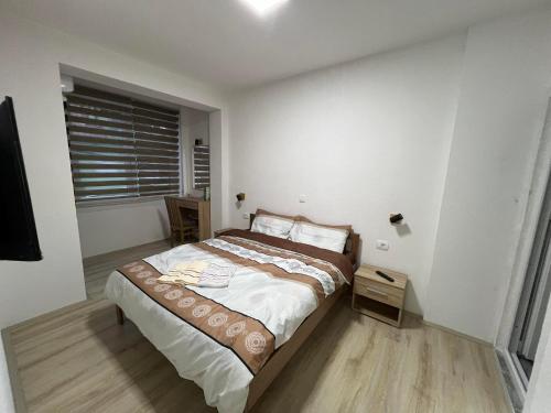 a bedroom with a bed in a room with a window at Royal Stars Apartments in Strumica