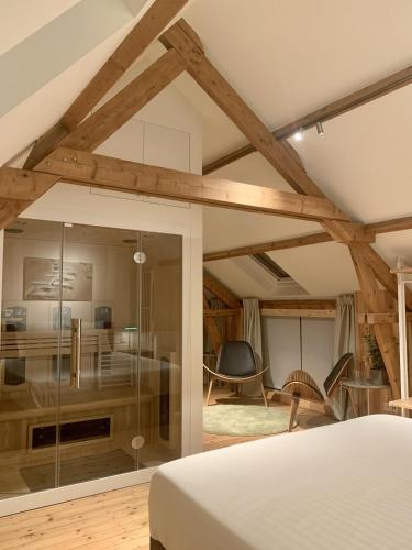 a bedroom with a bed and a glass wall at Gîte de Lombard 2 in Ieper