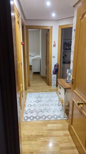 a room with a hallway with a table and a rug at Estudio Paloma in León