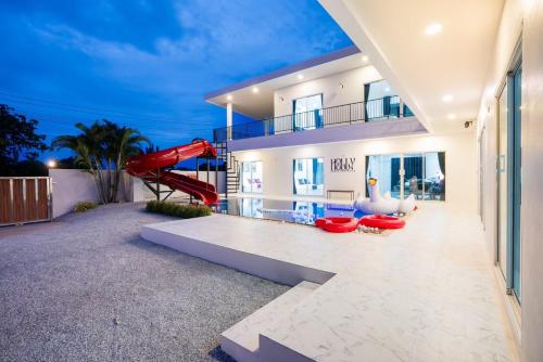 a house with a red slide in the backyard at Holly house poolvilla in Ban Huai Yai