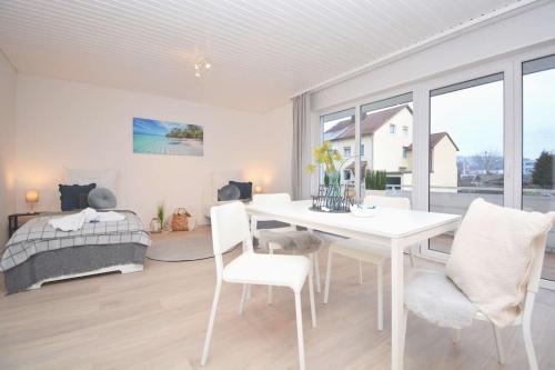 a white dining room with a white table and chairs at KU01-RI Apartment in Kulmbach EG in Kulmbach