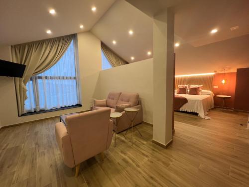 a room with chairs and a table and a bed at Casal de pelaio in Barreiros