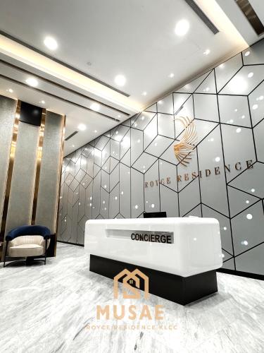a lobby with a reception desk and a wall at Royce Residence KLCC by MUSAE Kuala Lumpur in Kuala Lumpur