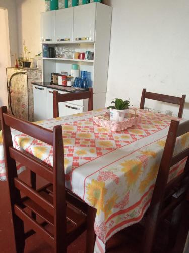 a kitchen with a table with a table cloth at Lazer Caraguatatauba ✓ in Caraguatatuba