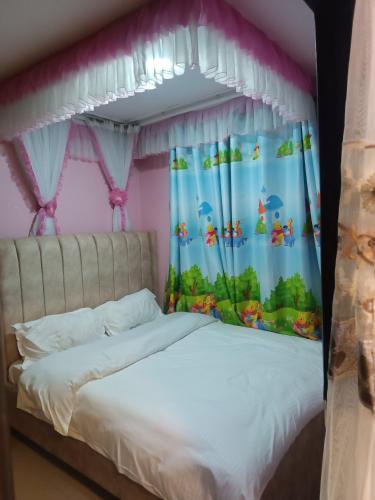 a bedroom with a bed with a disney themed bedspread at Angel Asenath 2Bedroom apartment in Nairobi