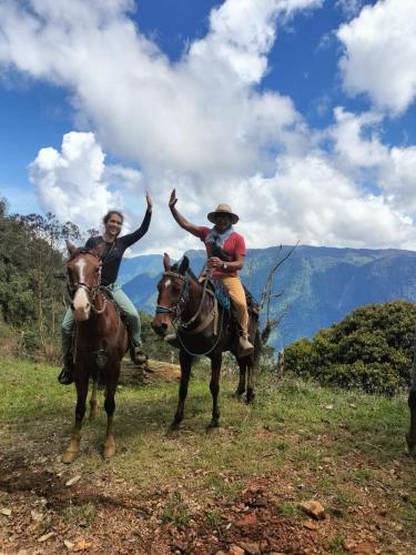 two people are riding horses on a mountain at Sierra de viboral adventures in Medellín