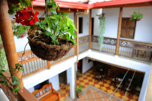 a model of a house with a red flower in a basket at S. Peppers Hostel in Jardin