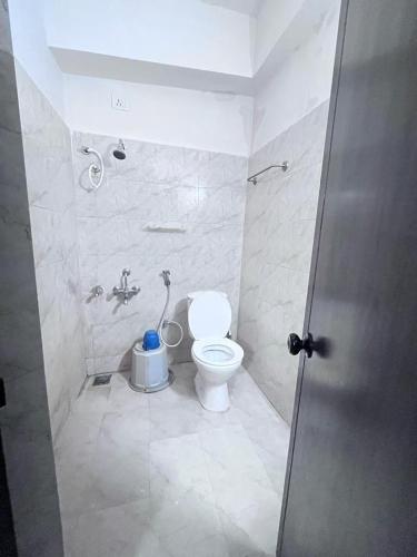 a bathroom with a toilet and a sink at Le Grace Annasalai in Chennai