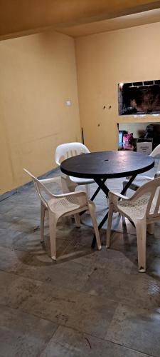 a table and two chairs in a room at Hosteria Edelweis in Villa Gesell