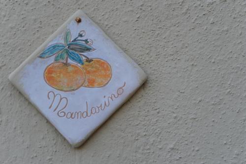 a sign with two oranges on a wall at Agriturismo La Contessa in Finale Ligure