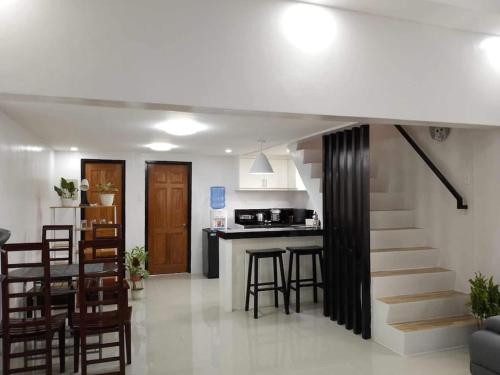 a living room with a staircase and a kitchen at Nestor's Apartment 