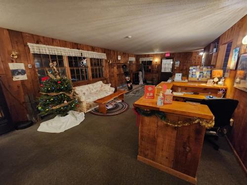 a living room with a christmas tree and a couch at Turn of River Lodge in Killington