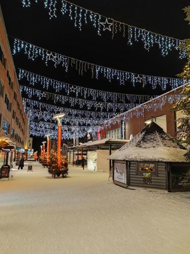 a building with christmas lights hanging over a street at City Apartment Tieva in Rovaniemi