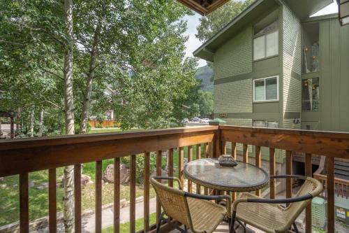 a balcony with a table and chairs on it at Cozy Tomboy Studio with private deck in Telluride