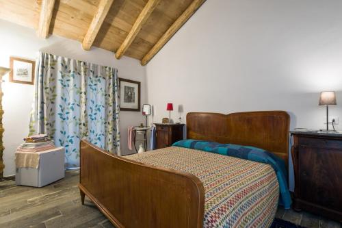 a bedroom with a bed and a dresser at Agriturismo La Contessa in Finale Ligure