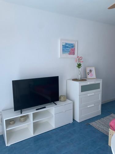 a white entertainment center with a flat screen tv at 14 Puerto del Carmen Ocean in Puerto del Carmen