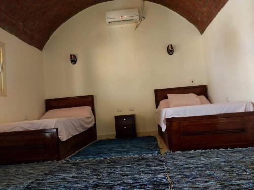 two beds in a room with at Antika camp in Nuweiba