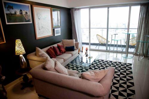 a living room with two couches and a large window at Chic Miraflores AC HEATER 16th floor in Lima