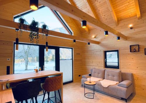 a living room with a couch and a table at Radovna Chalet with Panoramic View in Mojstrana