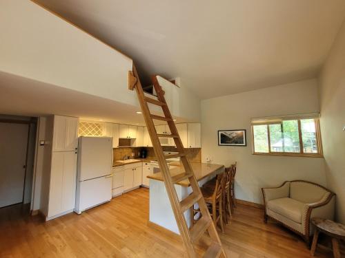 a kitchen with a ladder in the middle of a room at Quiet Lofted Studio at Tomboy Lodge in Telluride