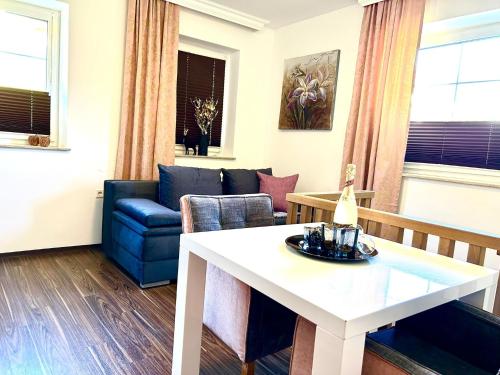 a living room with a table and a couch at Appartements-Dalila in Sankt Michael im Lungau
