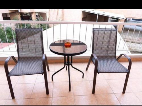 two chairs and a table on a balcony at Central appartment 2 with parking in Larisa