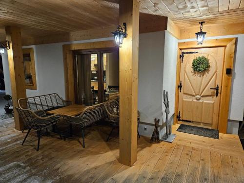a living room with a table and chairs and a door at Heidi in Zakopane
