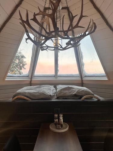 a window seat in a room with a chandelier at Northernlight cabin 2 in Kiruna