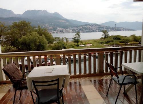 a balcony with a table and chairs and a view of a lake at Apartment Željka, Igalo - Herceg Novi in Igalo