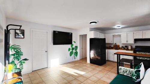 eine Küche mit weißen Schränken und einem schwarzen Kühlschrank in der Unterkunft Fresh & Bright Private Suite in Lower Sackville