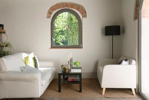 a living room with a white couch and a table at Casale La Gora - B&B di charme in Figline Valdarno