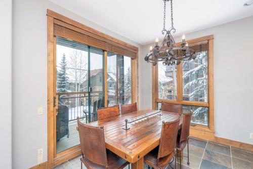a dining room with a wooden table and chairs at Ski in ski out Terraces Condo in Telluride