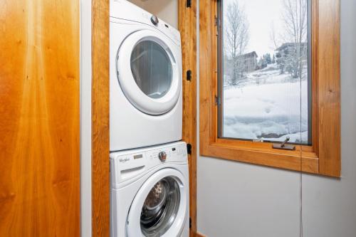 a washing machine in a room with a window at Ski in ski out Terraces Condo in Telluride
