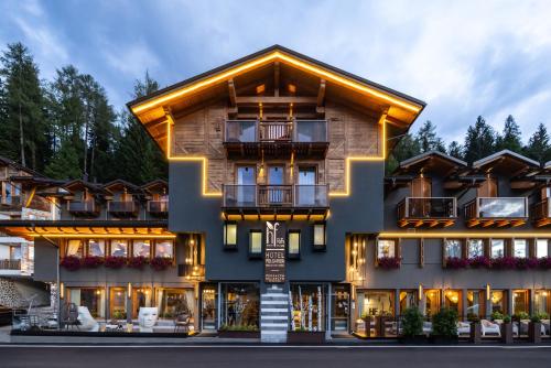 a hotel in the mountains with a building at Hotel Folgarida in Folgarida