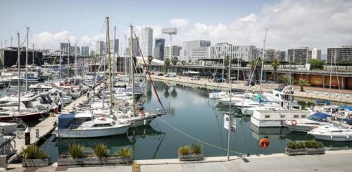 a group of boats docked in a marina in a city at Peace and Love in Badalona