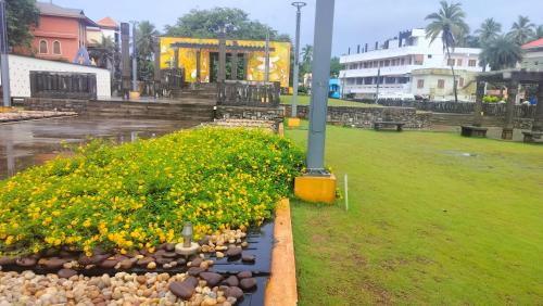 a bunch of flowers in a park in the rain at Banyan Tree Samudra in Kovalam