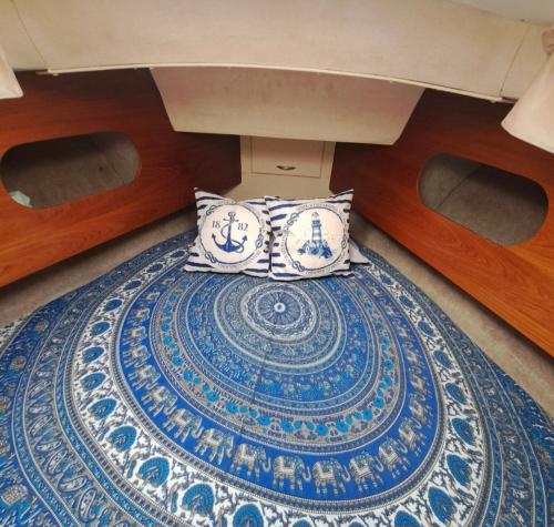 a pillow sitting on top of a blue and white rug at Peace and Love in Badalona