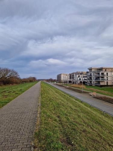 an empty road in a city with buildings at Pension Ostsee-Strand in Börgerende-Rethwisch