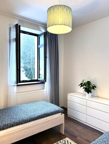 a bedroom with a bed and a window at Stará Škola Mariánská in Albrechtice v Jizerských horách
