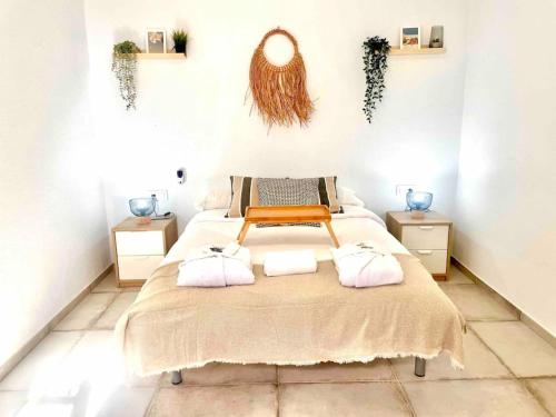 a bedroom with a large bed with two pillows at Brisa Home in Chiclana de la Frontera