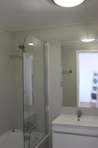 a bathroom with a shower and a sink and a mirror at Mel Apartment in Funchal