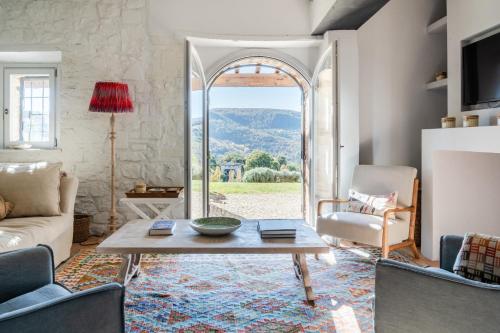 a living room with a couch and a table and a window at CASALE ORTALI by Miani Group in Pesciano