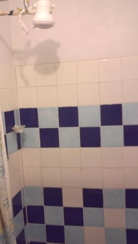 a bathroom with a blue and white tiled shower at Maracas Bay View in Maracas Bay Village